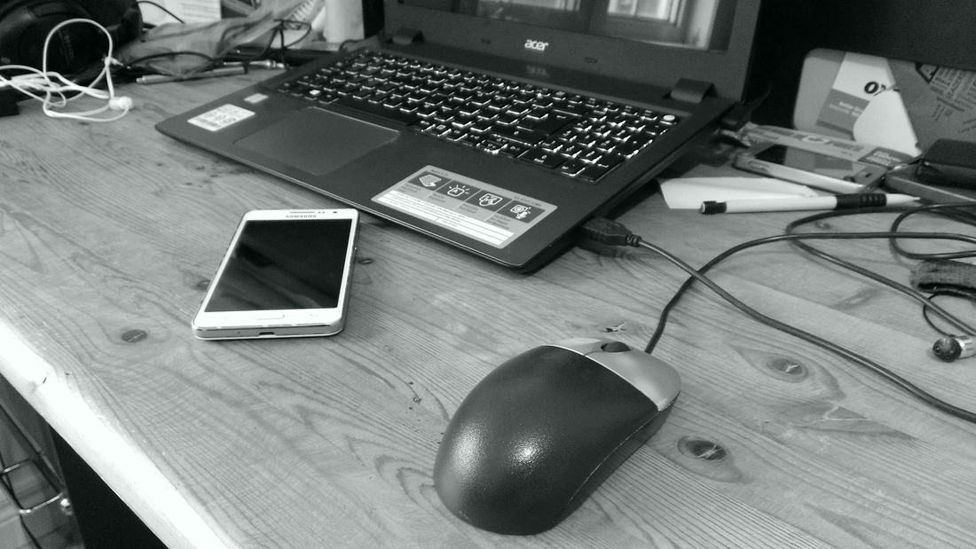 A laptop and phone on a desk